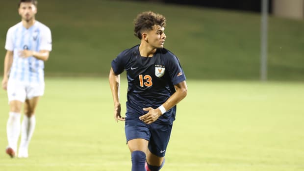 Cesar Cordova dribbles the ball during the Virginia men's soccer match exhibition against Villanova at Klockner Stadium.